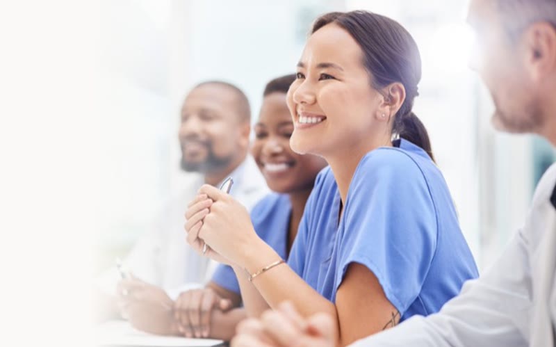 Healthcare workers smiling in a training session